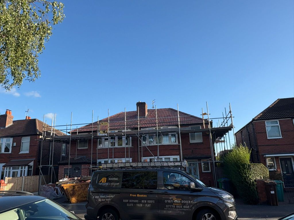 Red tiled roof installation on semi-detached home — After