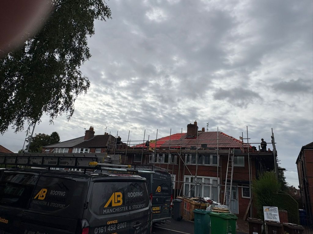 Red tiled roof installation on semi-detached home — After