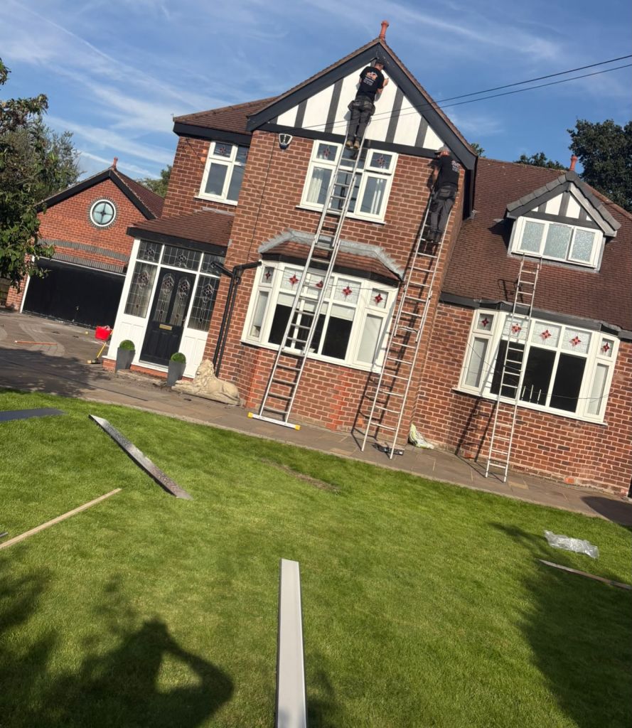 Red-brick home with a steep decorative gable and roofline details
