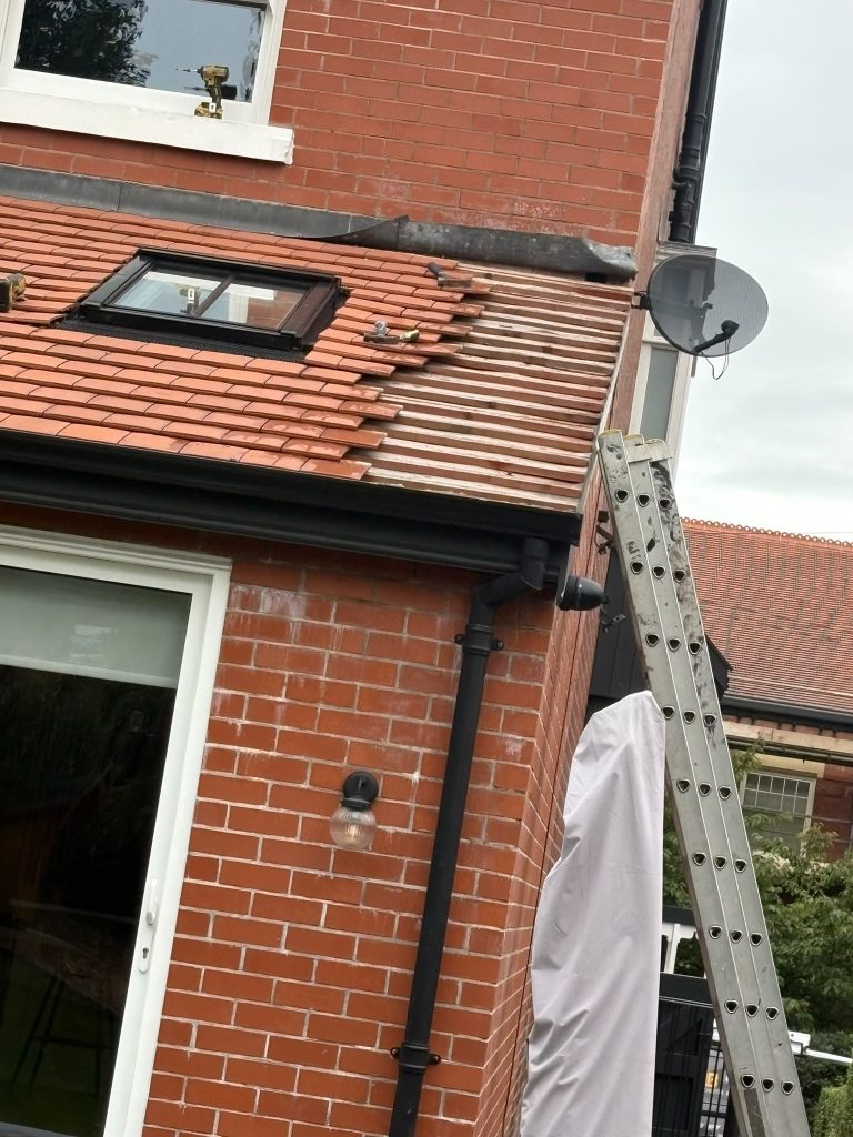 Red roof tiles and rooflight on a rear extension during installation